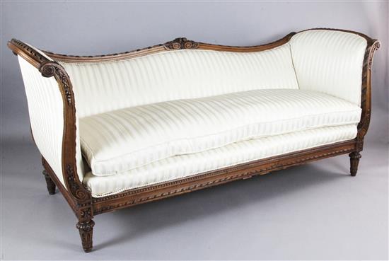 A Louis XVI style walnut serpentine settee, W.7ft 2in. D.2ft 10in. H.3ft 2in.